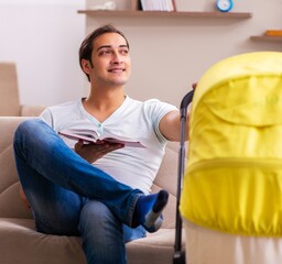 Young male contractor looking after new born at home
