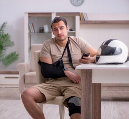 Fototapeta premium Young male motor-cyclist suffering at home after accident