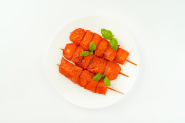 Raw marinated chicken fillet skewers on a white background.Marinated Fresh.Closeup of chicken meat.Procurement for designers.Chicken breast Fillets.