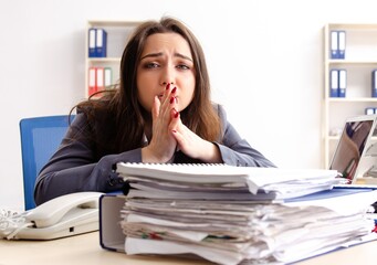 Young female employee unhappy with excessive work