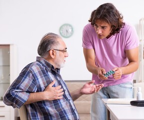 Young student and his old grandpa at home