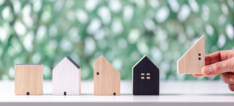 House model on table for finance and banking concept. Choosing the right real estate property, house or new home in a housing development or community. selective focus, Planning to buy property.