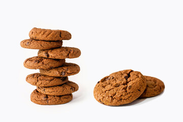 A stack of chocolate chip cookies on a white background. Delicious sweet homemade pastries beautifully stacked close up. Chocolate flavored homemade biscuits