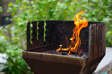 BBQ grill flame burning fire, barbecue outdoors for cooking food in garden. Big and tall grill...