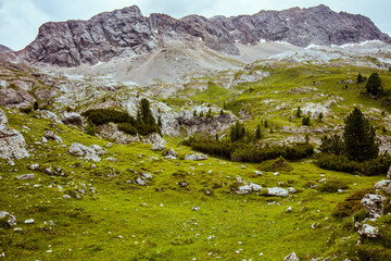 landscape with mountains, clouds, rocks and trees