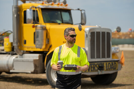 Men Driver Near Lorry Truck. Man Owner Truck Driver In Safety Vest Satisfied Near Truck. Millennial Trucker. Man Driver With Lunch Box. Truck Driver Having Lunch.