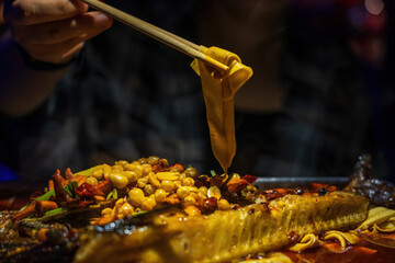 Grilling mackerel fish on a cast iron grill, close up view