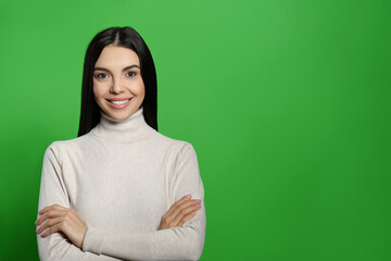 Chroma key compositing. Happy young woman with dark hair against green screen