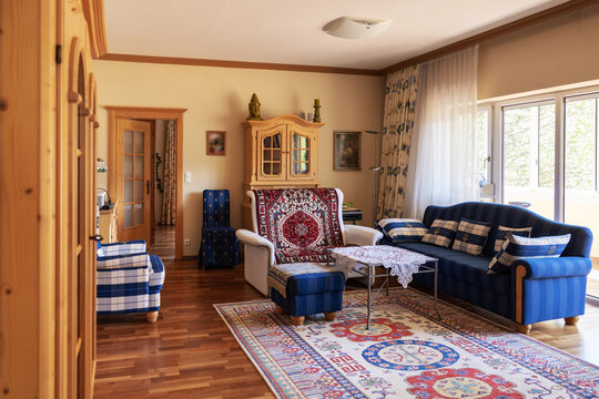 Private interior, a room with a sofa, armchairs, wardrobes and a large panoramic window with access to the loggia