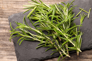 Fresh green rosemary on wooden table, above view
