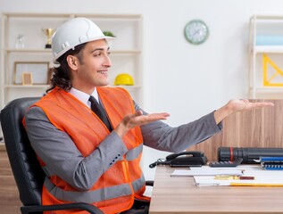 Young male architect working in the office