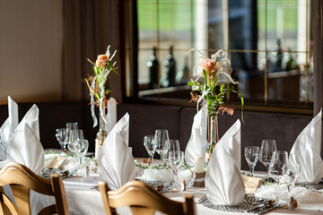Decorated Gala dinner table with wine glasses and decorative napkins for a wedding
