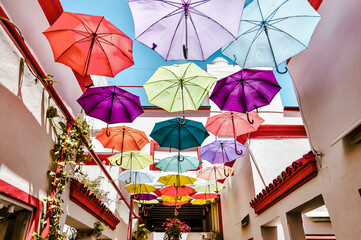 Buenos Aires, Argentina - December 21, 2022: Colourful umbrellas hanging above an open air market...