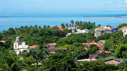 View of the architecture of the historic city of Olinda in Pernambuco, Brazil with its 17th century Baroque style buildings on cobblestone streets in the summer sun.