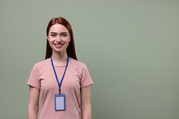 Smiling woman with vip pass badge on pale green background. Space for text