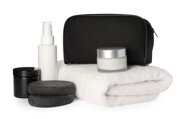 Compact toiletry bag, spa stones and different cosmetic products isolated on white