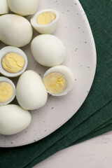 Many peeled hard boiled quail eggs on table, top view