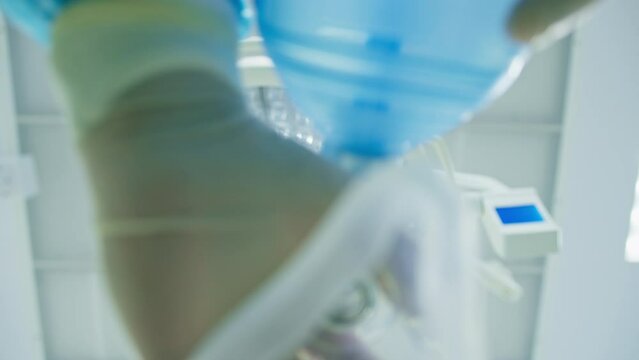 doctor anesthesiologist puts mask on patient for anesthesia during surgery close-up hospital operating room healthy