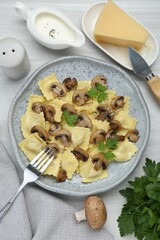 Delicious ravioli with ingredients on white wooden table, flat lay