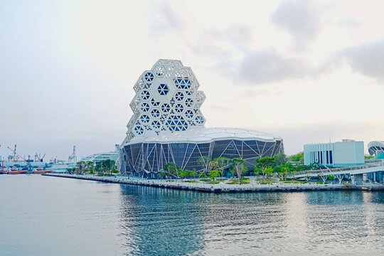 Kaohsiung, Taiwan - April 20, 2023: Kaohsiung Music Center (KMC). The white hexagonal building structure on the riverbank in Kaohsiung, Taiwan.