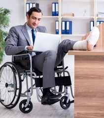 Male employee in wheel-chair in the office