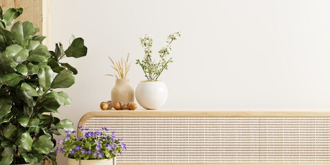 Wall mockup featuring a vase and a vibrant green plant, set against a backdrop of white walls and cabinet.3d rendering