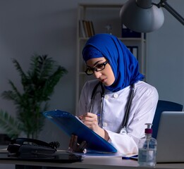 Arab female doctor working in the clinic at night
