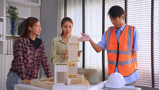 Asian young businessman amputee without arm work with team in office.