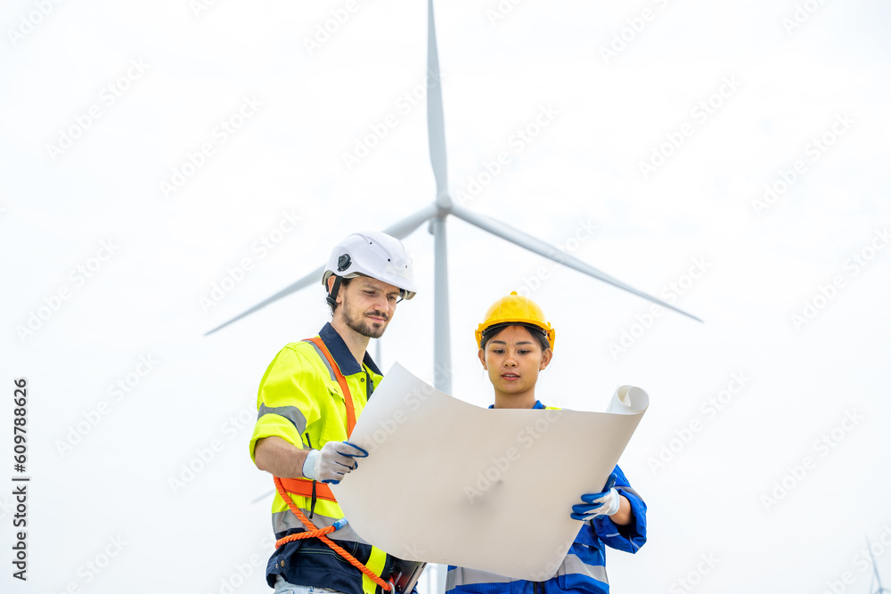Poster engineer working at renewable energy farm,inspector controlling functioning of wind turbines outdoor