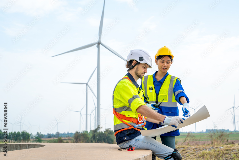 Poster group of engineers are working with a blueprint in wind turbine farm,wind power station,renewable an