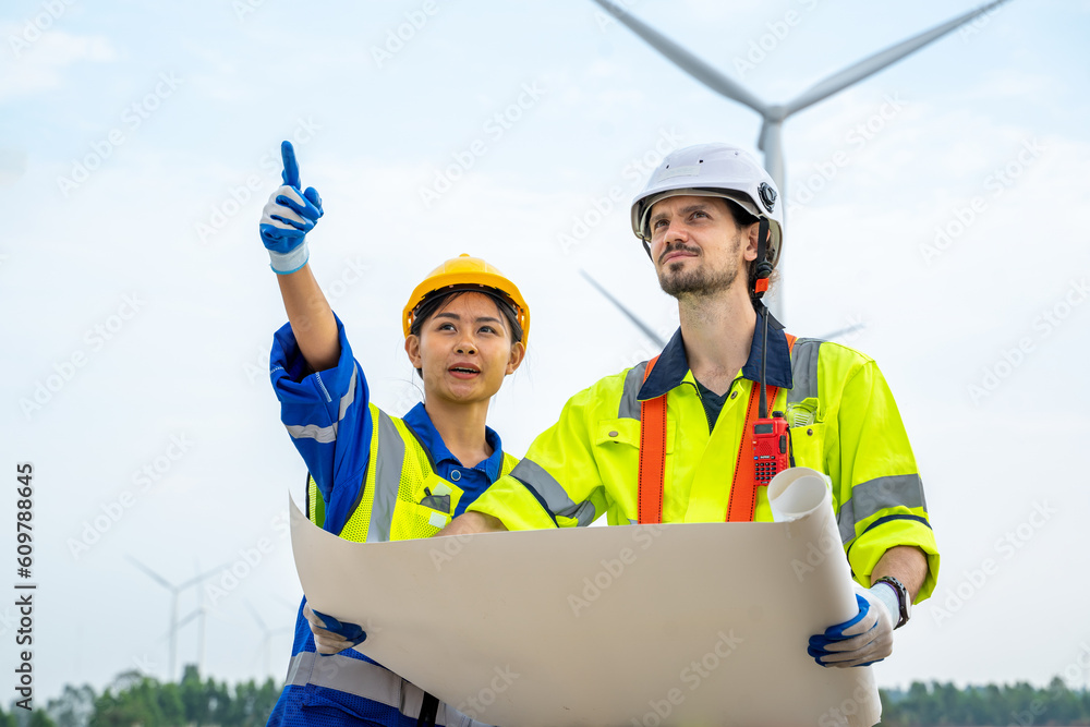 Poster technician engineer in uniform are checking wind turbine power farm, power generator station,clean e