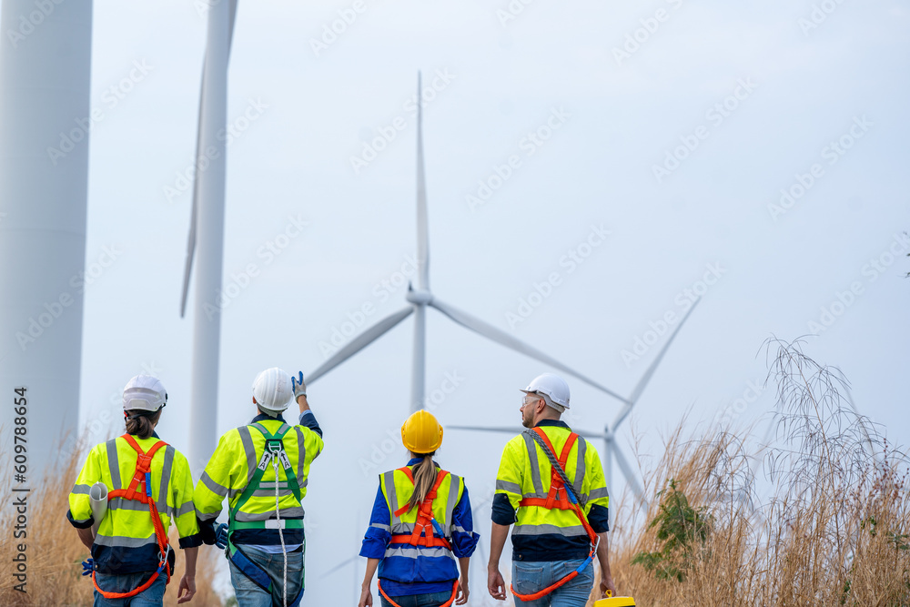 Poster group of engineers planning discuss project ann working in wind turbine farm,sustainable future.