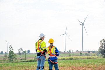 Fototapeta na wymiar Technician engineers inspection work in wind turbine power generator station,Wind turbine operations that transform wind energy into electrical electricity.