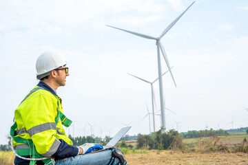 Technician Engineer in uniform are checking wind turbine power farm, Power generator station,Clean energy and environment.