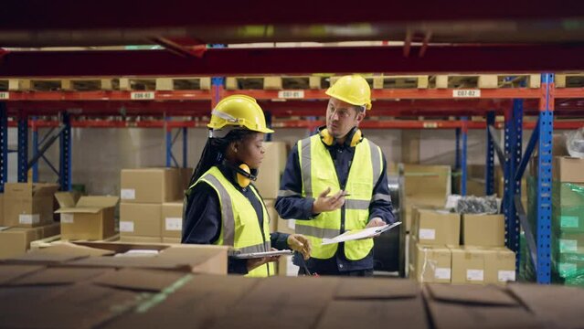 Diverse industrial worker team working in manufacturing plant together.