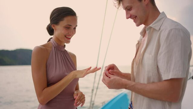 Caucasian young man make surprise proposal of marriage to girlfriend. 