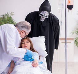 Devil, old doctor and female patient in the clinic