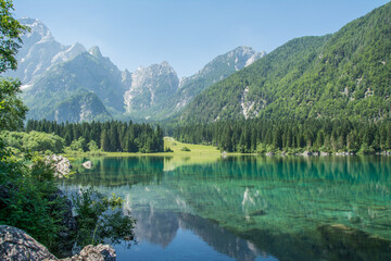 Fototapeta na wymiar View of Lago di Fusine, Italy, Europe. Reflection of the mountains in a lake. 