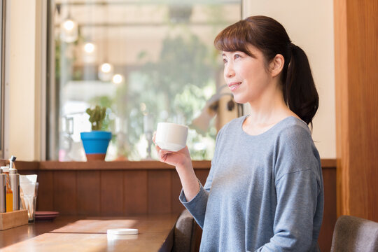 カフェでコーヒーを飲む女性
