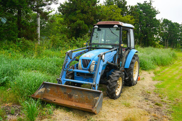 Tractor machine stopped in a green field