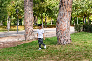 Young boy alone. having fun in a park.