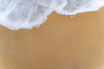 Light blue sea waves on clean sandy beach. Sea beach and soft waves of blue ocean