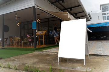 White paper poster mockup displayed outside the building. Marketing and business concept. Displayed in front of restaurants, coffee shop promotion information.