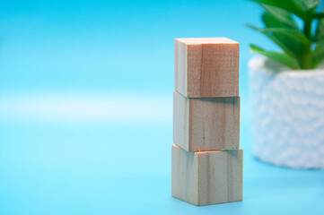 Wooden cube stacked on white cover background. Customizable space for text. Copy space.