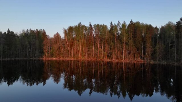 View of calm, smooth Tündre lake during sunset in spring, Estonia.