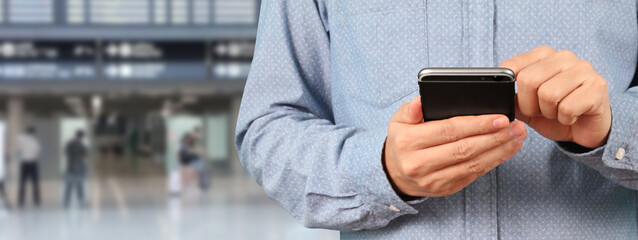 Man holding smartphone device and touching screen with five star rating
