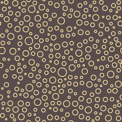 Seamless vector background with random brown and yellow circles. Abstract ornament. Seamles abstract pattern