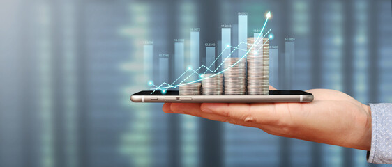 Hand holding smartphone device and touching screen. Stock exchange market concept. looking