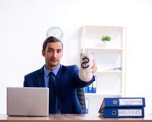 Young male accountant working in the office