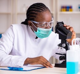 Young black chemist working in the lab